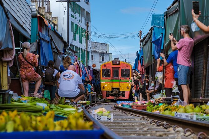 Amphawa Floating Market & Maeklong Railway Train Market Tour - Wat Bang Kung: banyan roots, Buddha statues, and a free temple stop