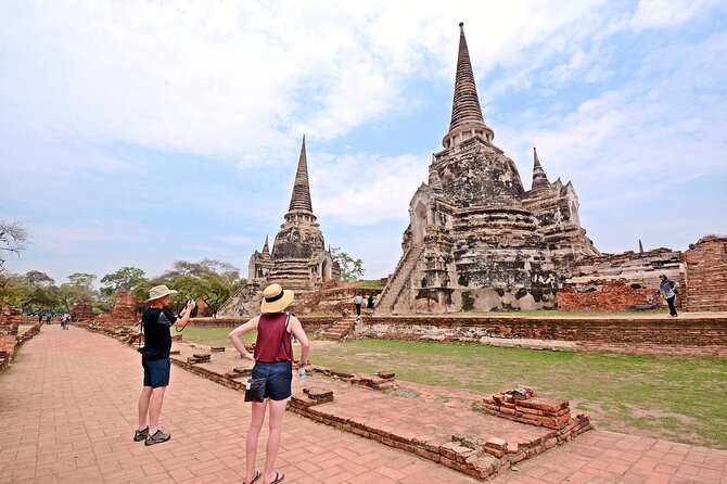 Ayutthaya Sunset Tour: UNESCO Temples & Peaceful River Cruise - Wat Mahathat: The Tree Roots and the Buddha Head Moment