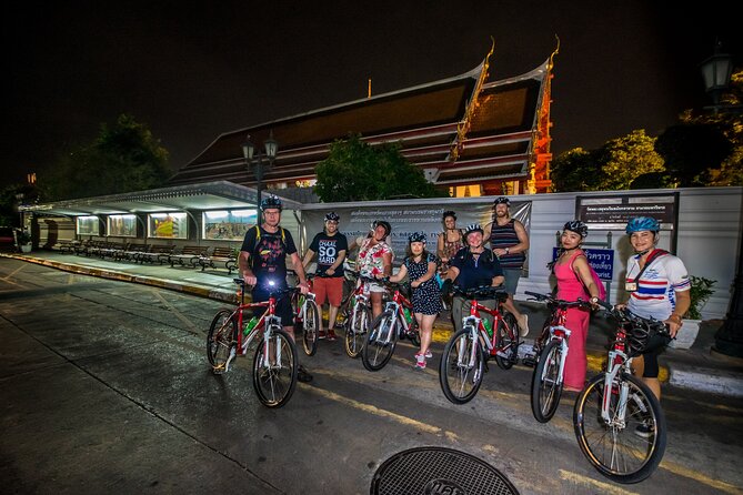 Bangkok: Night Bike Tour with Temples & Flower Market Visit - Pak Khlong Talat after dark: flowers, produce, and real smells