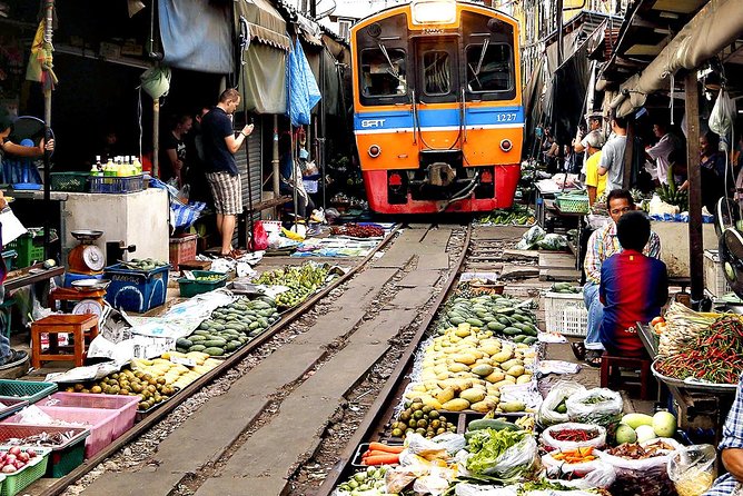 Famous Markets Tour: Maeklong Railway & Damnoen Saduak Floating - Maeklong Railway Market, where the stalls pull back for trains