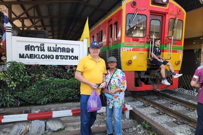 Private Maeklong Railway Market and Amphawa Day Tour from Bangkok - Mae Klong Railway Market (Hoop Rom Market): Where the Train Controls the Stalls